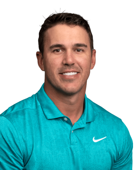 Brooks Koepka in a blue t-shirt poses for a photo.